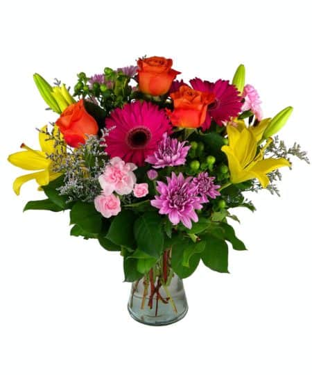 Break out of that gray days gloom with this bright and beautiful bouquet! Sunny Lilies, orange Roses, gorgeous Gerbers, Mini-Carnations, Daisies, Coffee Berry, and more are arranged in a gathering vase.